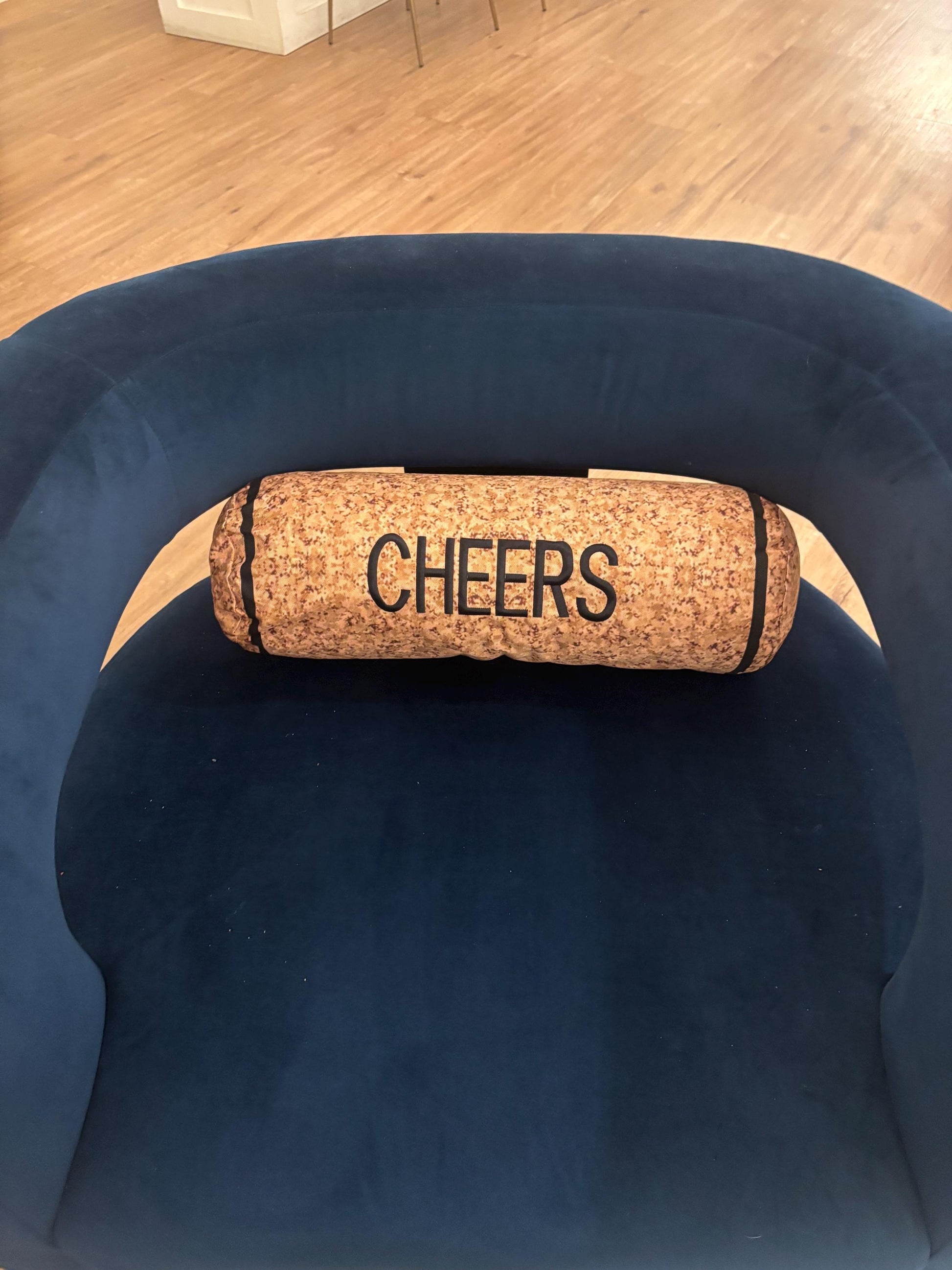 Cork shape wine cork pillow embroidered CHEERS . Also, has a zipper to easy clean and Perfect winelover gift and great decor for any room